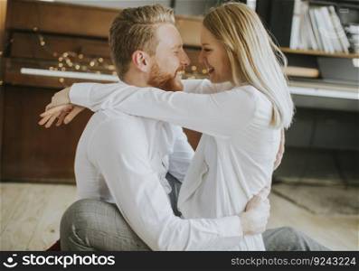 Happy and loving couple kissing in the room
