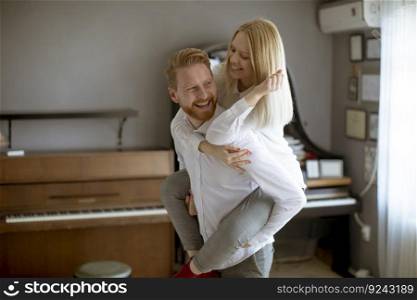 Happy and loving young couple having fun in the room