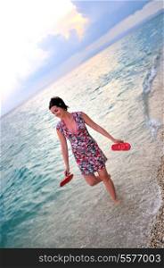 happy and pretty woman alone walking on beach