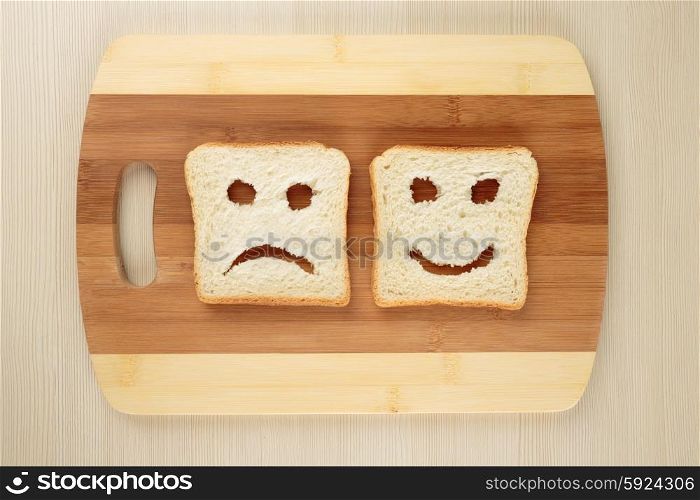 Happy and sad on a cutting board