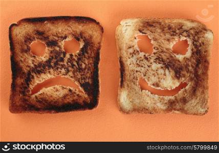 Happy and sad toast on a cutting board