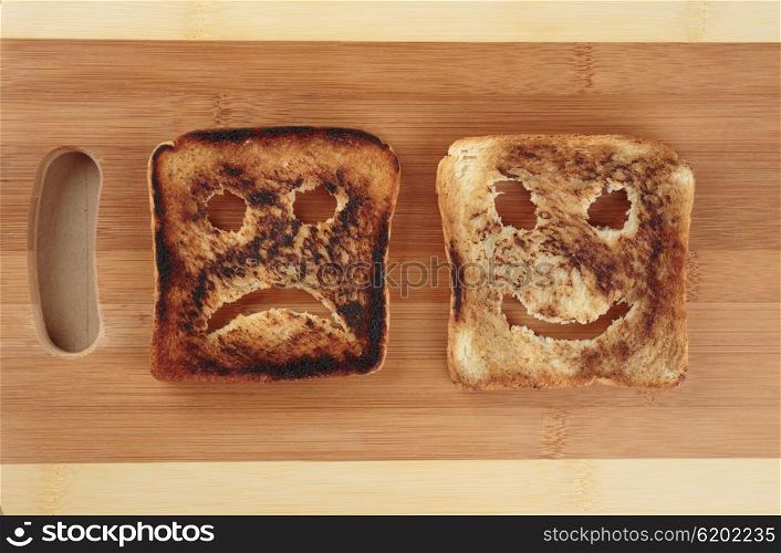 Happy and sad toast on a wooden cutting board