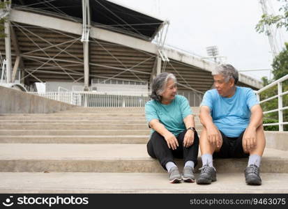 Happy and smile couples elderly asian sitting on stairs for rest after workout, jogging on morning, senior exercise outdoor for good healthy. Concept of healthcare and active lifestyle for healthy