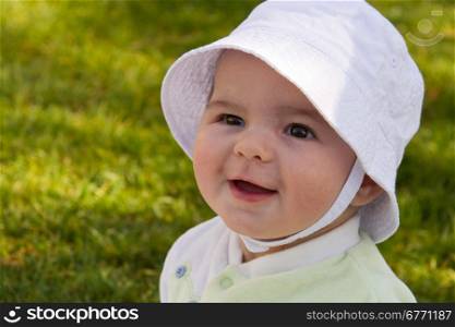 Happy and smilling baby wearing hat outdoors