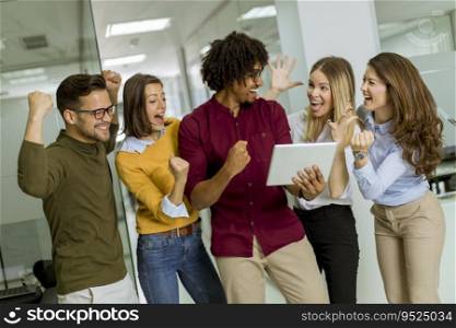 Happy and  successful young people are standing in a modern office