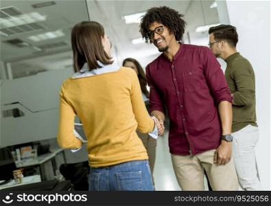 Happy and  successful young people are standing in a modern office