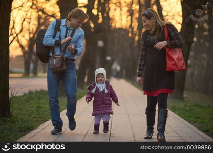 Happy and young pregnant couple have fun and relax outdoor