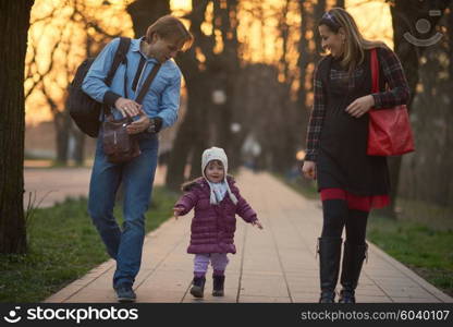 Happy and young pregnant couple have fun and relax outdoor