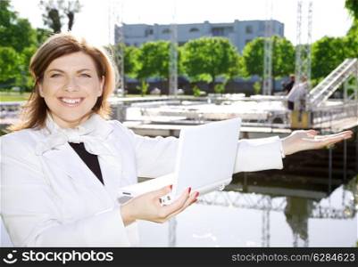 happy architect woman standing in front of a building site
