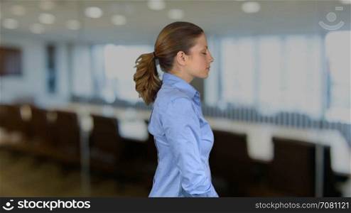 Happy arms crossed working female professional in an office