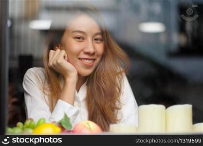 Happy asia girl, Portrait of young asian woman smiling and looking at camera while sitting indoor in casual lifestyle