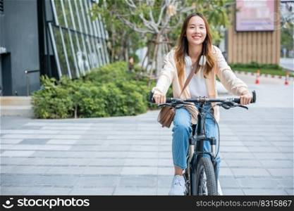 Happy Asian beautiful young woman riding bicycle on street outdoor near building city, Portrait of smiling female lifestyle using bike in summer travel means of transportation, ECO friendly