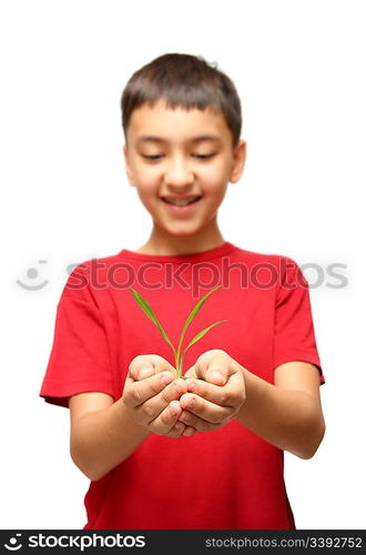 happy asian boy holding green plant in hands