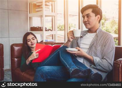Happy Asian couple drink coffee at home. Love relationship and lifestyle concept.