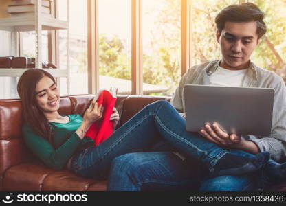 Happy Asian couple relax in living room. Love and relationship concept.