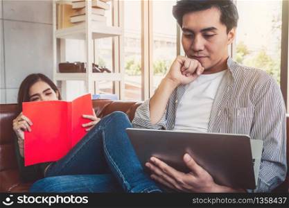 Happy Asian couple relax in living room. Love and relationship concept.