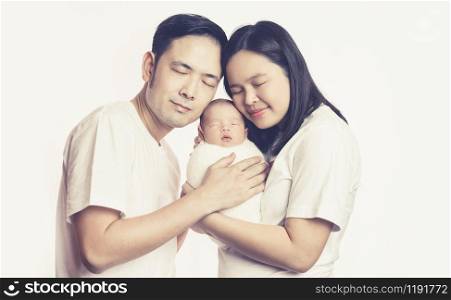 Happy Asian family of mother father and baby son in the studio shooting portrait embrace together smiling with eyes closed. Parenthood and family relationship concept.