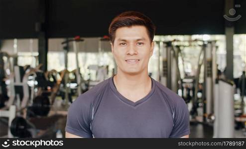 Happy Asian healthy sport man trainer with sportswear smile looking at camera feel cheerful and fresh after workout in gym, People training use in fitness class, sport and healthy lifestyle concept.