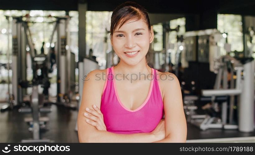 Happy Asian healthy sport woman trainer with sportswear smile looking at camera feel cheerful and fresh after workout in gym, People training use in fitness class, sport and healthy lifestyle concept.