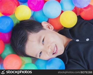 Happy Asian kid with colorful toy balls