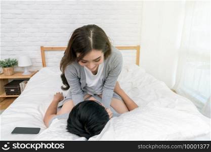 Happy Asian Lover kissing and hugging on the bed in bedroom at home, Couple and life style concept,