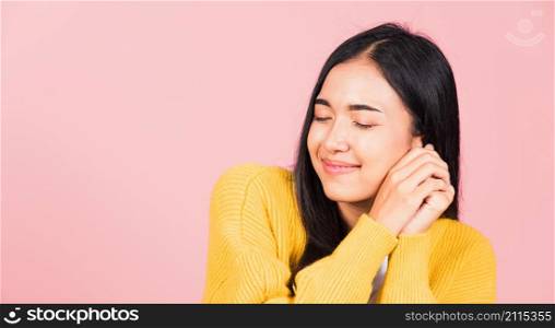 Happy Asian portrait beautiful cute young cheerful mixed race woman smile shy satisfied expression, studio shot isolated pink background, Thai female bashful pleasure put both hand on face, copy space