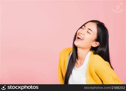 Happy Asian portrait beautiful cute young woman standing winning and surprised excited screaming laughing look face up, studio shot isolated pink background, Thai female smiley funny with copy space
