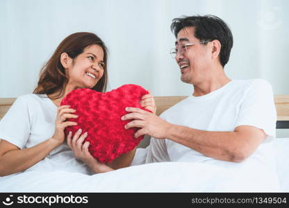 Happy Asian senior couple having good time at home. Old people retirement and healthy citizens elderly concept.