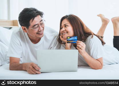 Happy Asian senior couple having good time at home. Old people retirement and healthy citizens elderly concept.