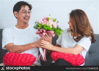 Happy Asian senior couple having good time at home. Old people retirement and healthy citizens elderly concept.
