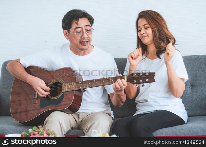 Happy Asian senior couple having good time at home. Old people retirement and healthy citizens elderly concept.