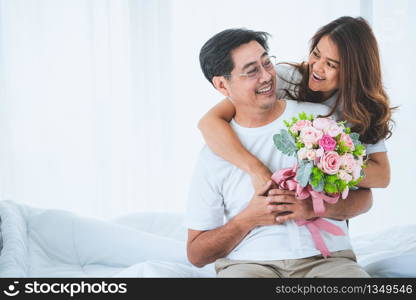 Happy Asian senior couple having good time at home. Old people retirement and healthy citizens elderly concept.