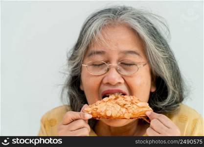 Happy Asian senior women enjoying eating pie