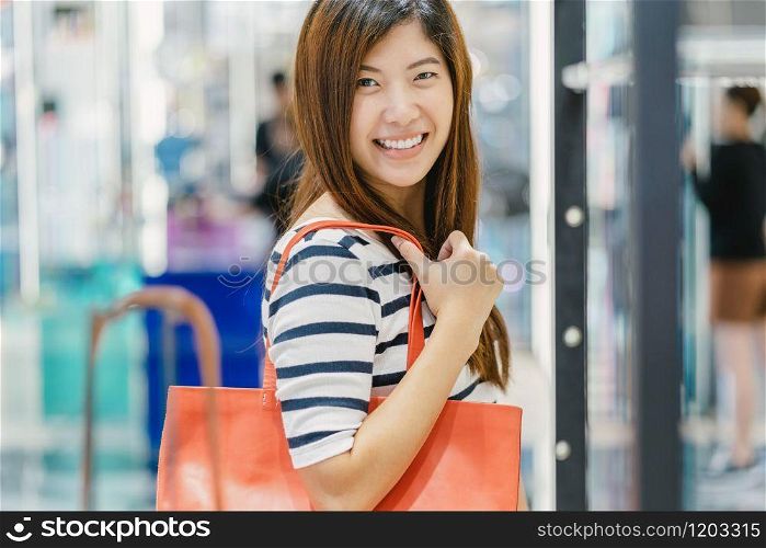 Happy Asian woman choosing the women bag store shop with happy action at department center