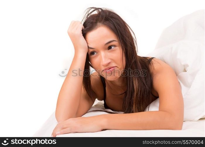 Happy asian woman in bed, isolated over a white background
