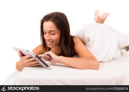Happy asian woman in bed working with a tablet computer