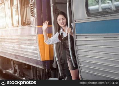 Happy Asian woman pregnant hand up say hello and red bag on the train travel railway station travel,traveler with backpack in summer Holiday concept Thailand