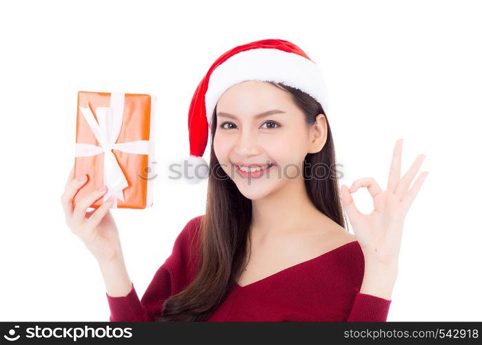 Happy asian woman with smile holding gift box of xmas, Present girl with celebration christmas, girl gesture ok isolated on white background, shopping with season concept.