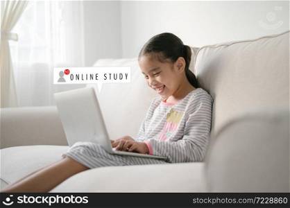 Happy asian young girl studying online on laptop, , student choosing e-learning program, while in quarantine isolation during the Covid-19 health crisis.