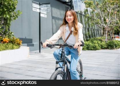 Happy Asian young woman riding bicycle on street outdoor near building city, Portrait of smiling female lifestyle use mountain bike in summer travel means of transportation, ECO friendly, Urban biking