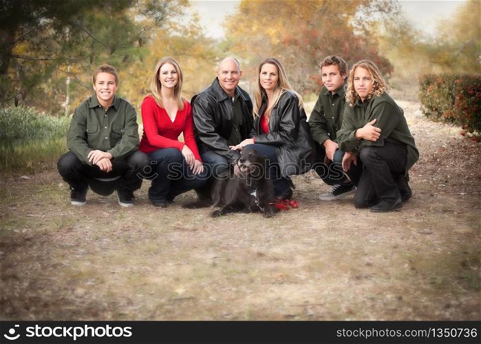 Happy, Attractive Family Pose for a Portrait Outdoors.