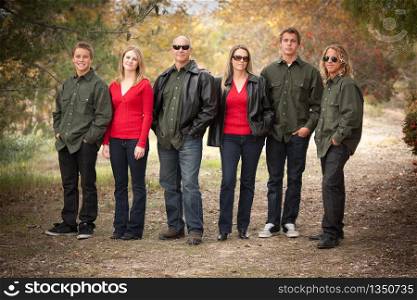 Happy Attractive Family Standing Portrait Outdoors.