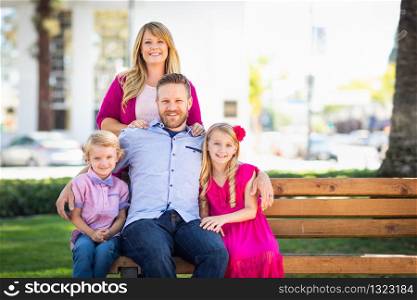 Happy Attractive Young Caucasian Family Portrait in the Park.
