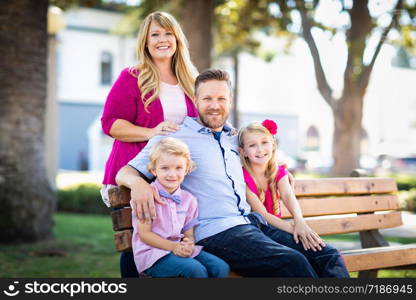 Happy Attractive Young Caucasian Family Portrait in the Park.