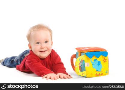 Happy baby boy (6 months old) playing with soft toys, smiling. Toys are property released.