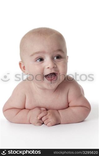 Happy baby boy lying on his belly on white background
