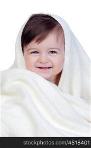 Happy baby covered with a towel isolated on white background