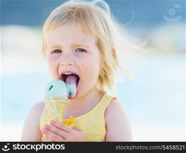 Happy baby eating ice cream