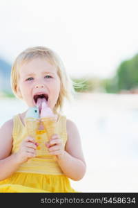 Happy baby eating two ice cream horns