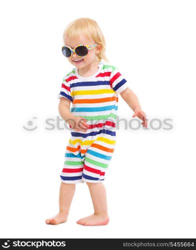 Happy baby in swimsuit and sunglasses dancing